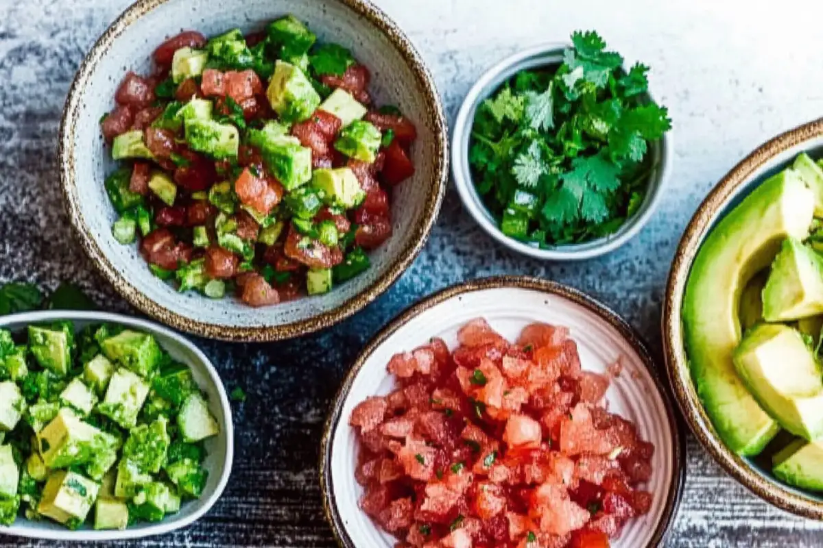 Fresh toppings like avocado, pico de gallo, and cilantro in small bowls.