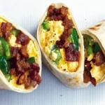 Classic breakfast burrito with eggs, bacon, vegetables, and cheese.