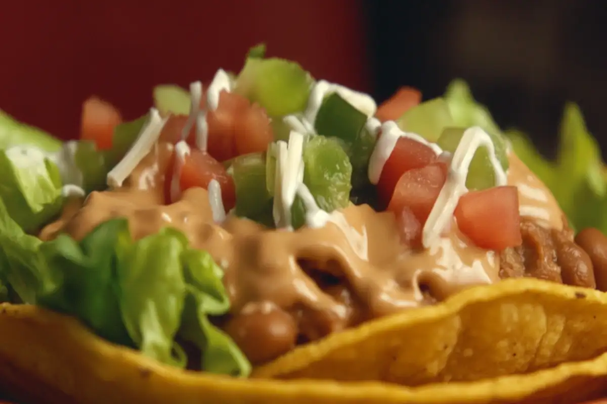 Close-up of a crispy tostada with fresh toppings