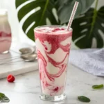 Hailey Bieber viral smoothie with pink and white swirls in clear glass with straw"