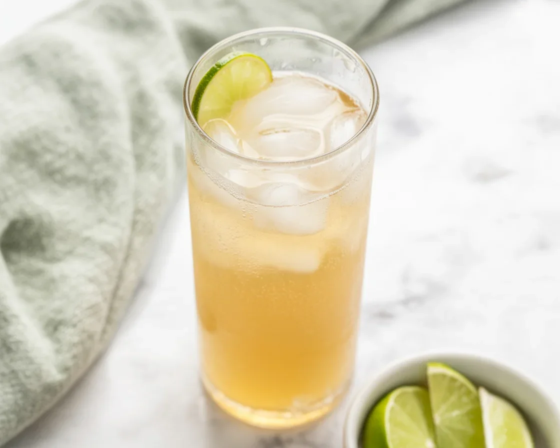 Glass of homemade ginger ale made with ginger, sugar, and sparkling water.