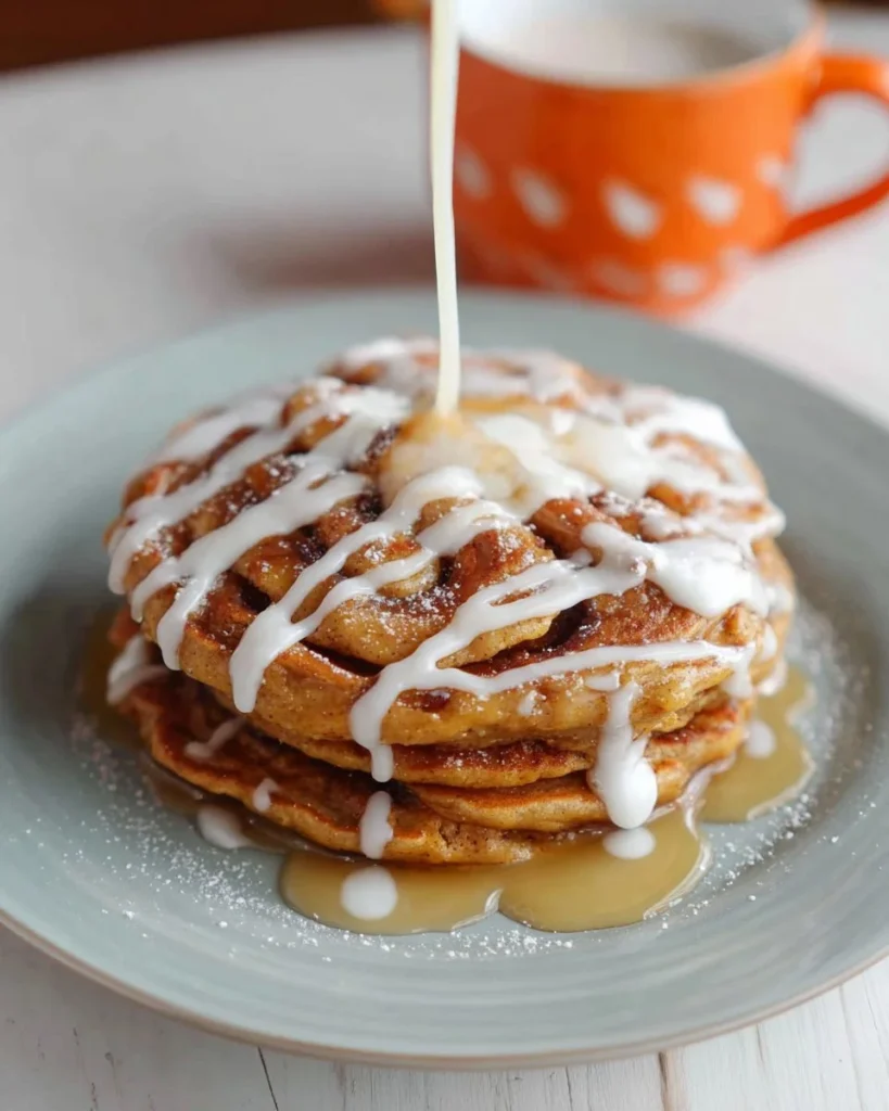 Cinnamon Swirl Pumpkin Spice Pancakes drizzled with Cream Cheese Glaze