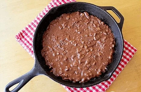 Gluten-free chocolate fudge skillet cake served warm with a scoop of ice cream