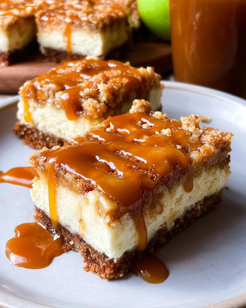 Delicious Caramel Apple Cheesecake Bars topped with caramel drizzle.