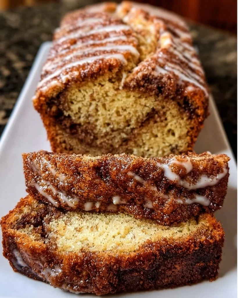 Slice of cinnamon swirl banana bread on a wooden board