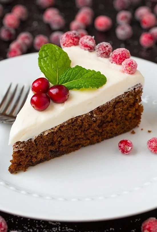 Delicious gingerbread cake slices with cream cheese frosting on a festive table