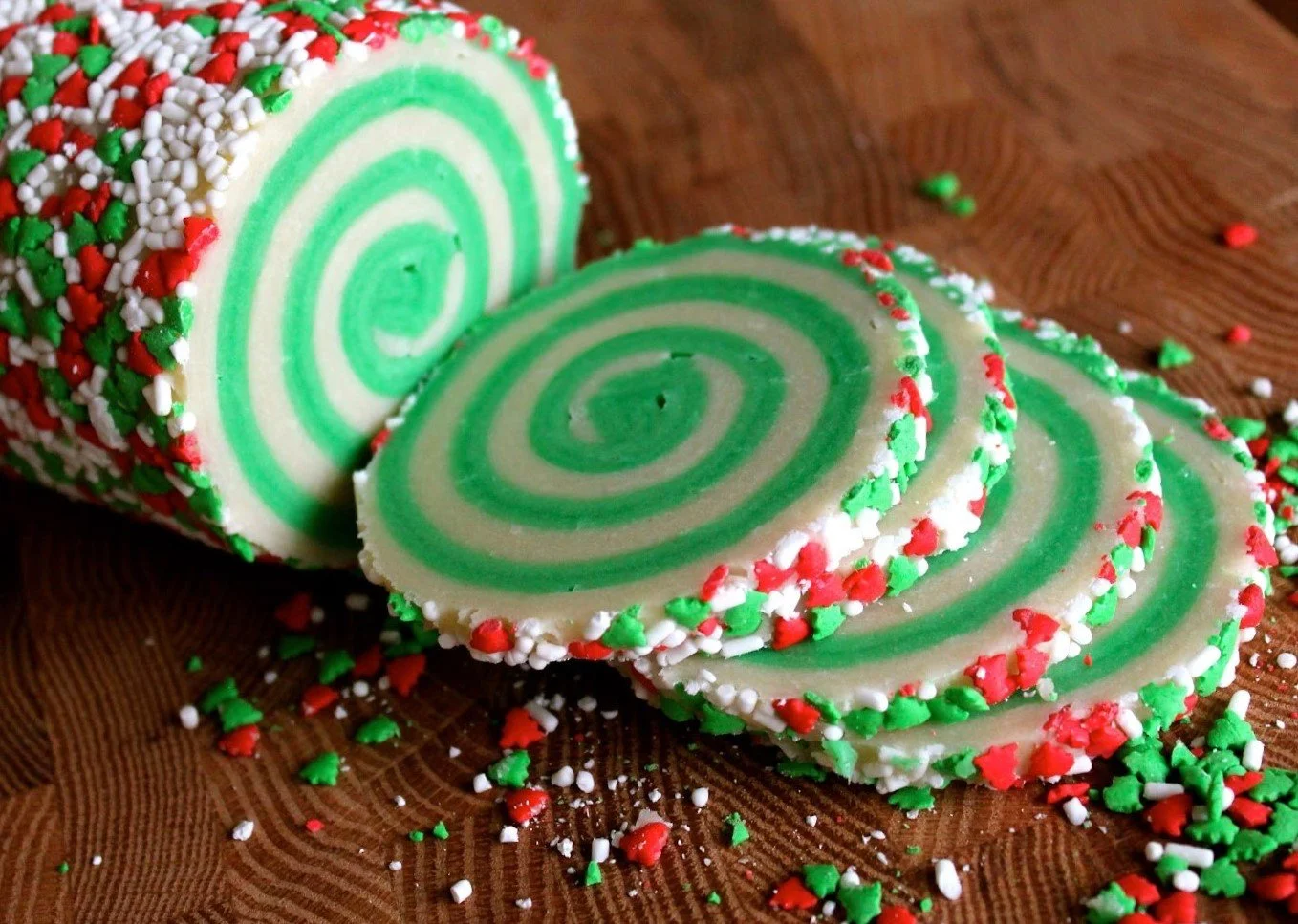 Plate of colorful Christmas pinwheel cookies decorated for the holidays