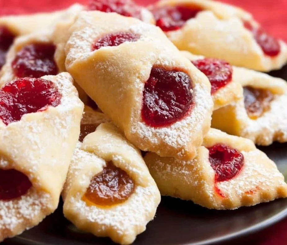 Delicious Polish Kolaczki cookies filled with fruit preserves on a plate