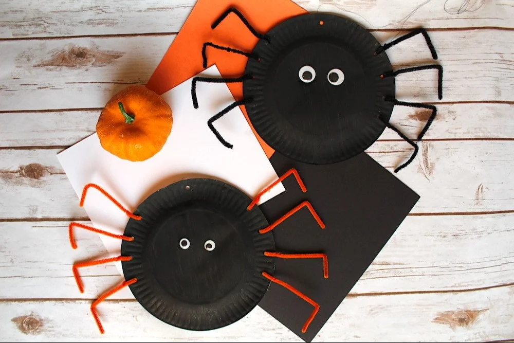 Colorful paper plate spider craft with googly eyes and pipe cleaner legs