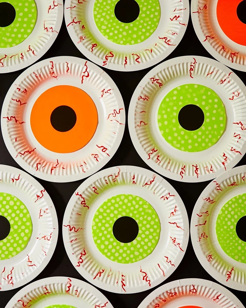 Halloween paper plate featuring spooky eyeball designs for festive parties.