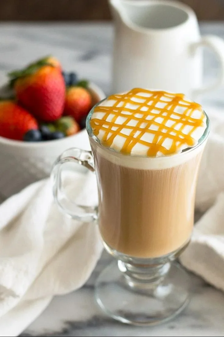 Delicious Caramel Macchiato topped with caramel drizzle in a coffee cup