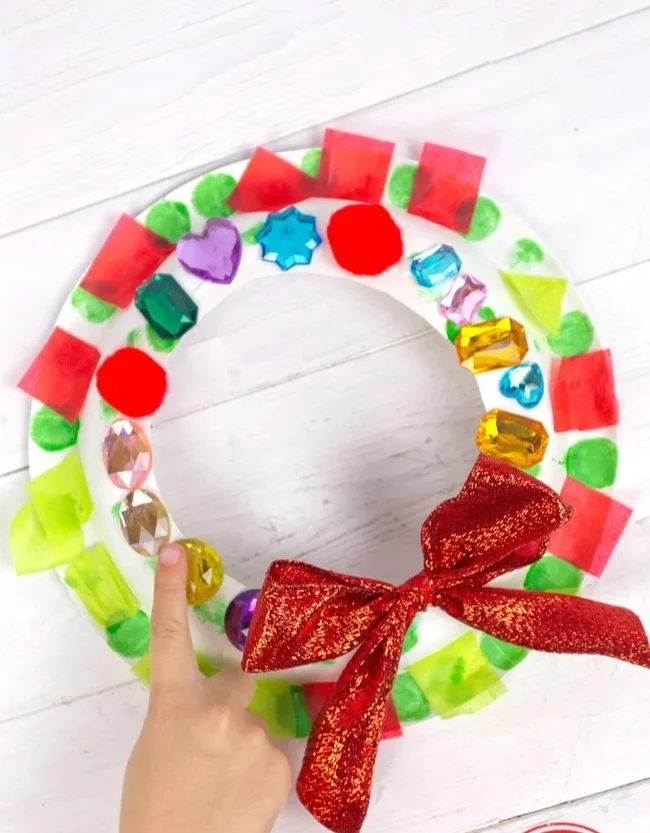 Easy Christmas wreath craft for kids made from a paper plate.