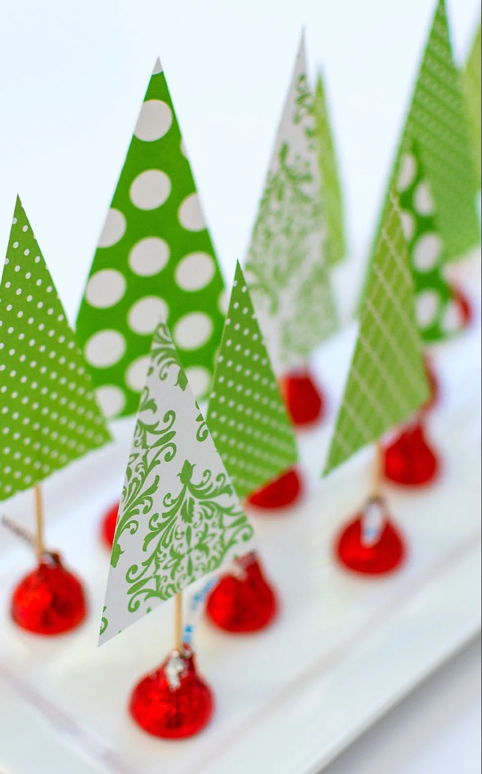 Kiss mass tree centerpiece decorating a holiday table setting.