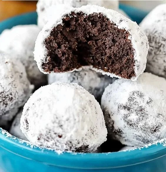 Homemade double chocolate snowball cookies dusted with powdered sugar.