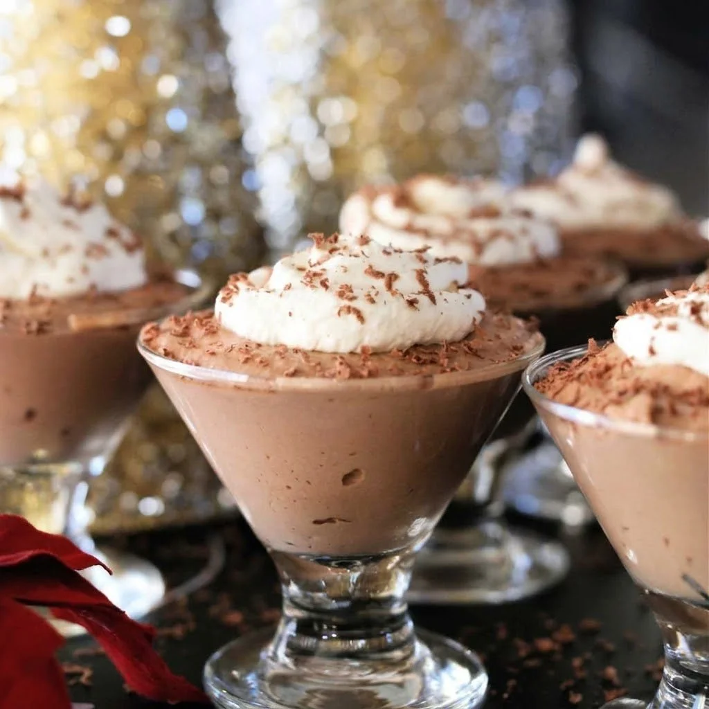 Delicious Kahlua chocolate mousse dessert topped with whipped cream and cocoa powder.